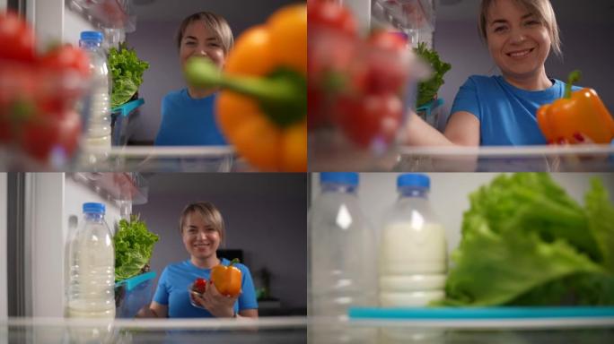 积极的成年妇女从冰箱中摄取蔬菜