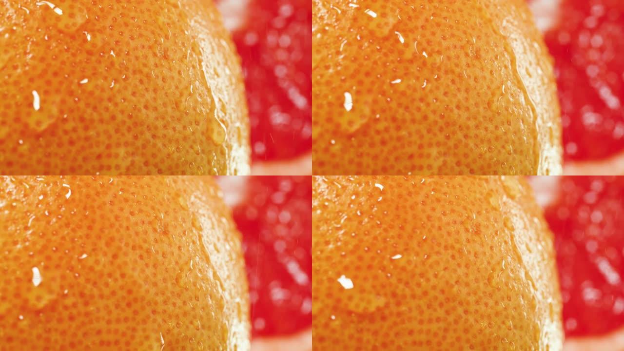 新鲜成熟橘皮的水滴下落和滚动的慢动作。有机食品和健康营养的完美抽象镜头。柑橘类水果的特写