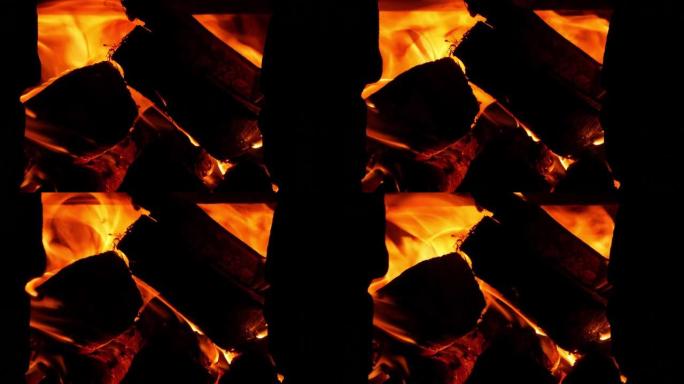 在农村烤箱里烧柴。黑暗中木头炉子的红色橙色火焰。舒适的热壁炉篝火燃烧在晚上。明亮温暖的屏幕保护4K，