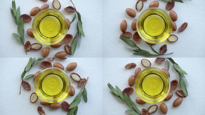 白色背景上的摩洛哥坚果油和种子。基于摩洛哥坚果油的化妆品概念