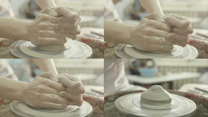 女陶工的手在风轮上塑造了陶土陶罐。原始视频记录