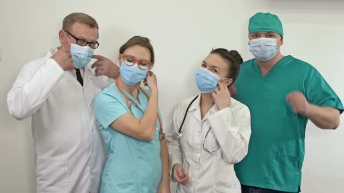一群医生放下医用口罩。新型冠状病毒肺炎大流行已经被击败