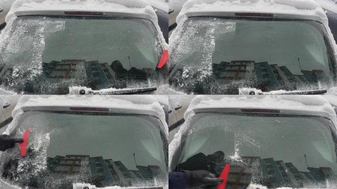 男人用雪刷擦车。冬天暴风雪过后，人们在汽车上刷新鲜的雪。冬季寒冷天气车主的困难