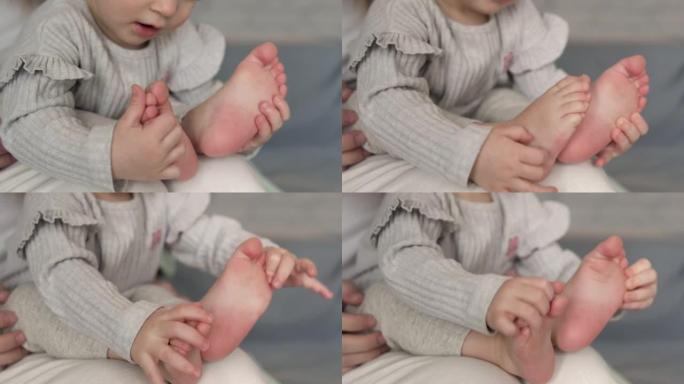 可爱的好奇漂亮的小宝宝玩腿，数着脚趾，挠痒痒的脚