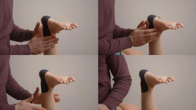 理疗师将kinesio胶带贴在女性患者的脚跟上，运动学胶带，运动学疗法，运动员受伤后正在康复，4k 