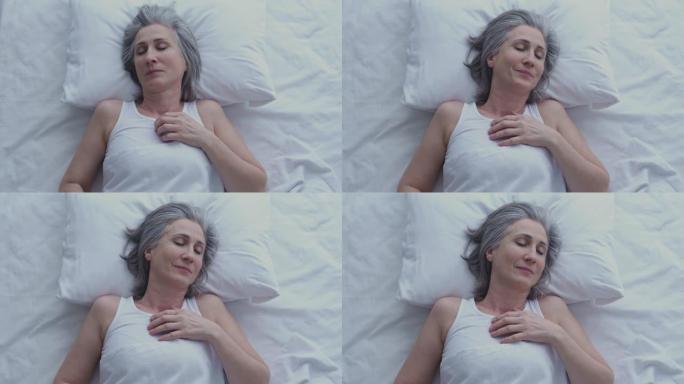成熟的白发女人在睡觉时感觉冻僵，睡眠条件不好