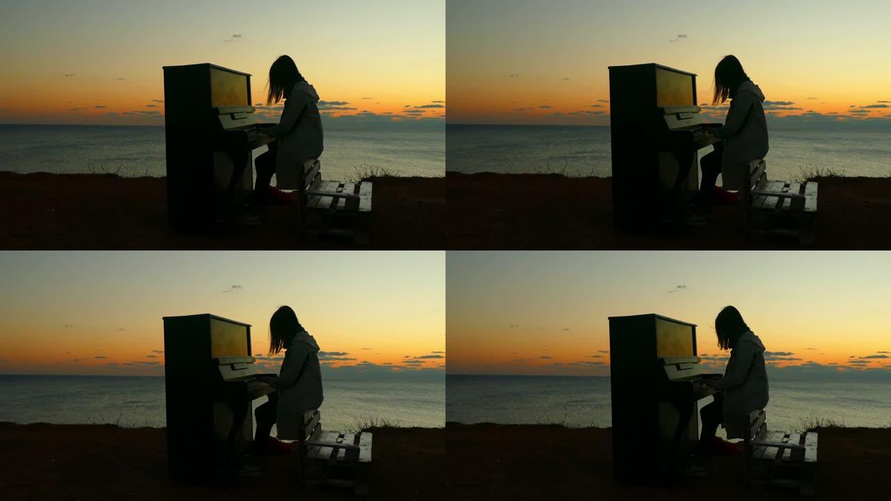 海岸上弹钢琴的女孩的日落剪影