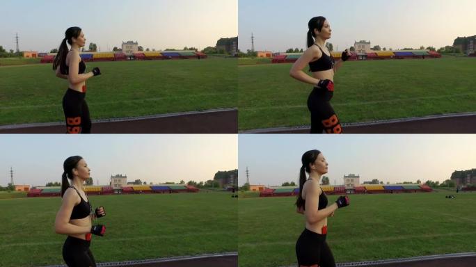 俄罗斯克麦罗沃-2018年7月11日: 慢动作。年轻的女运动员在户外跑步机上在体育场跑步