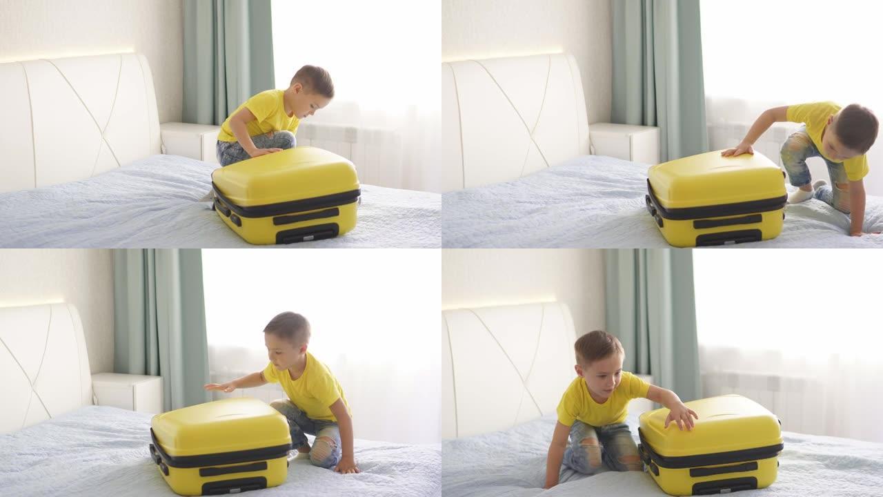 可爱的婴儿试图在房间里打开一个手提箱