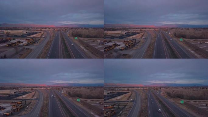 日落时在科罗拉多州大章克申附近的70号州际公路上行驶的车辆的空中拍摄