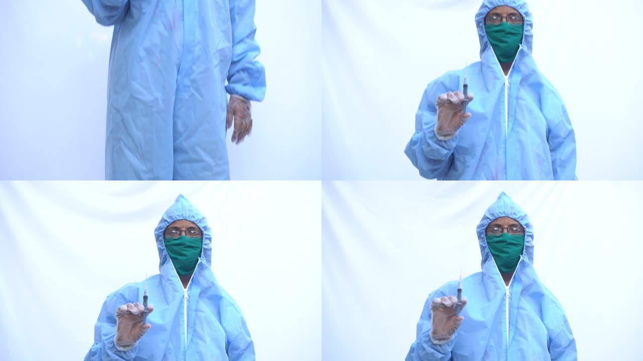 医生在PPE套件蓝色防护服，外科口罩乳胶手套。医生拿着注射器