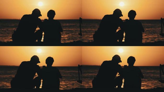 剪影一对中年男女日落在海边的海滩上