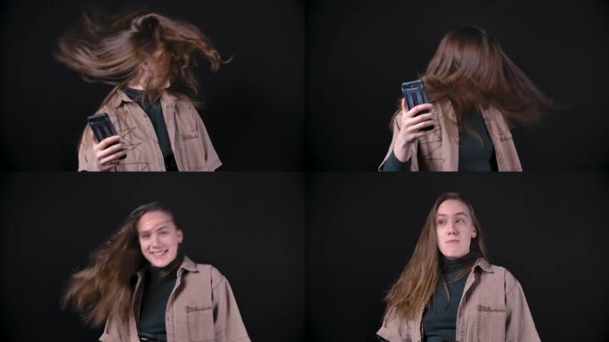 手持智能手机颤抖头发的少女慢动作视频