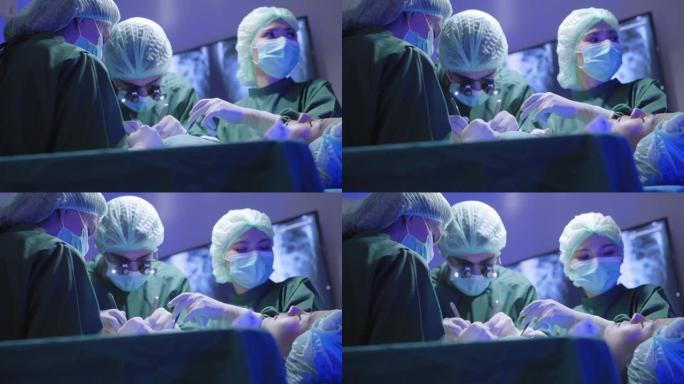 一名戴着双目放大镜的外科医生的低角度视角，致力于挽救她的性命，亚洲女性患者躺在医院手术室的床上延长寿