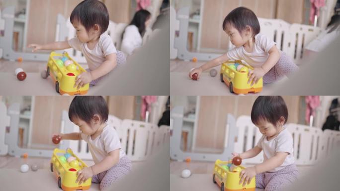 健康的亚洲小孩在家里的游戏室里玩玩具，妈妈要小心她，幼儿学龄前的技能发展，快速成长的孩子，婴儿安全和