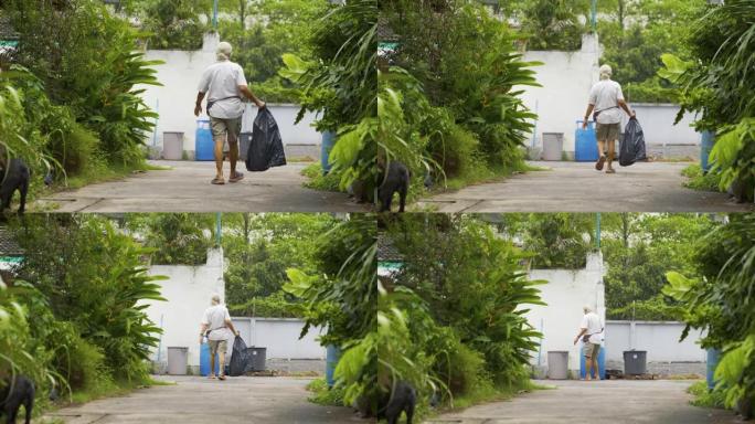 4k亚洲男子清理垃圾袋，然后放在离开他家的前面。