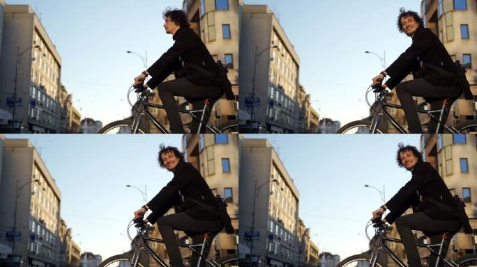 年轻商人上班时骑自行车的肖像-城市环境
