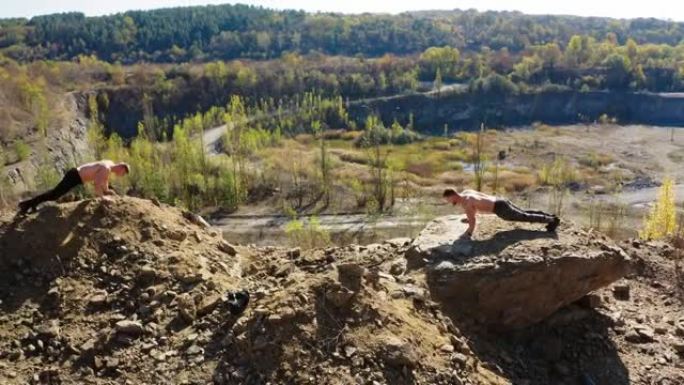 运动员做俯卧撑。年轻运动员在户外俯卧撑的鸟瞰图