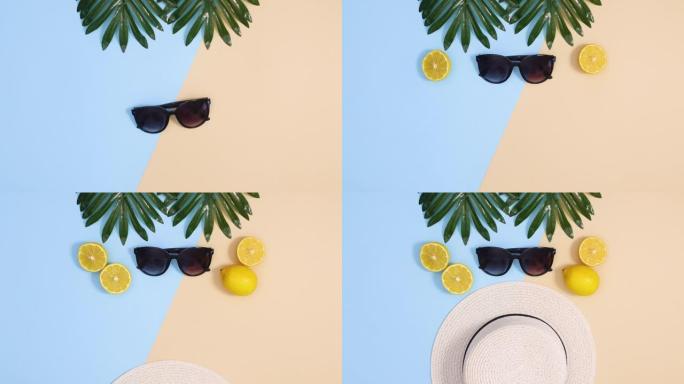 暑假概念停止运动平躺。夏季帽子和太阳镜与柠檬和热带叶子一起出现