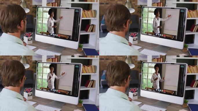 高加索男老师在电脑上与女老师进行视频通话时做笔记