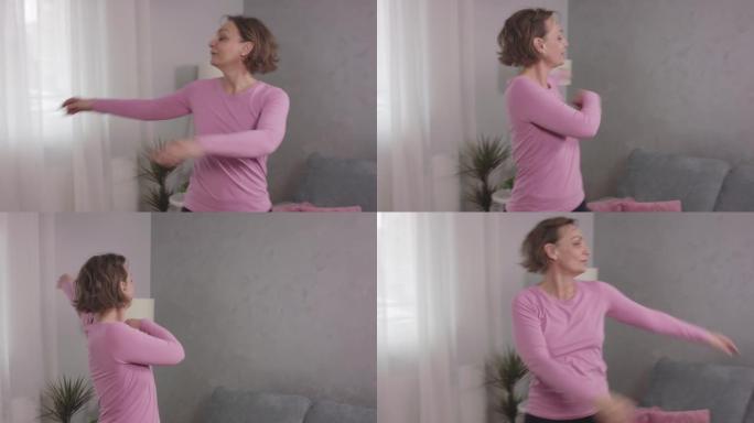 活跃的成熟女性在家庭锻炼中挥动手臂