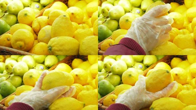 检疫期间，年轻迷人的女人在超市挑选成熟的有机柠檬。年轻女子在超市里选择有机柠檬。一名年轻女子的手戴着