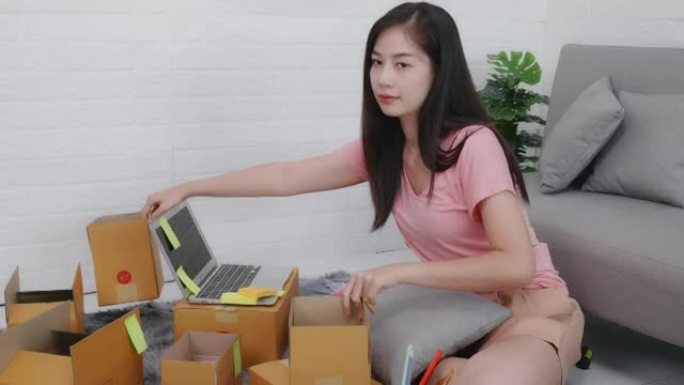 网上商店小企业主女性亚洲企业家包装包装后装运箱为客户准备送货包裹