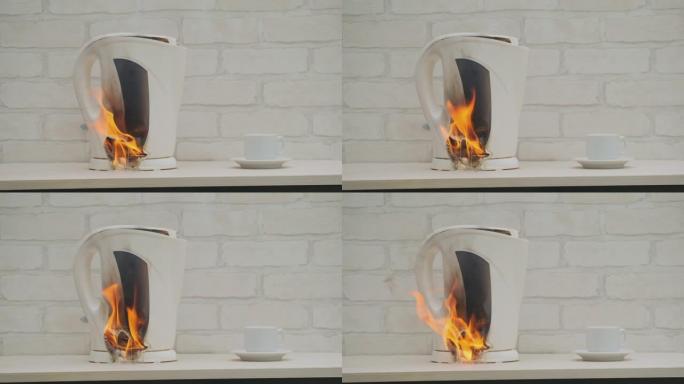 塑料电热水壶在家里的厨房里用火燃烧并融化在桌子上。房屋火灾原因的概念