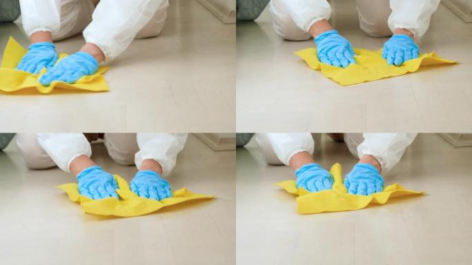 女管家或家庭主妇的特写镜头，用化学洗涤剂或清洁剂在家中消毒和清洁地板。