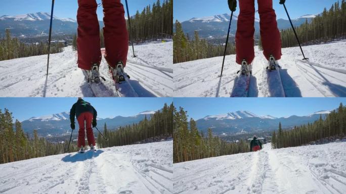 低角度滑雪者夹在一对滑雪板上，并开始以慢动作向滑雪胜地推下山下