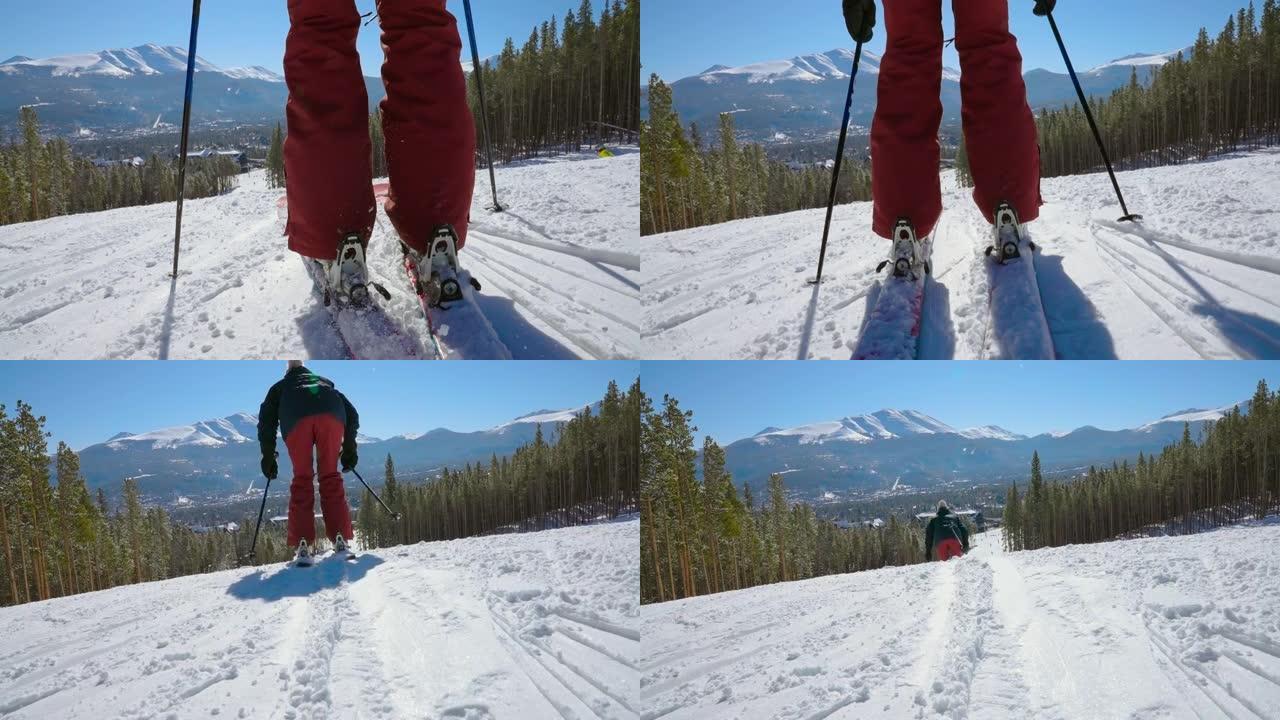 低角度滑雪者夹在一对滑雪板上，并开始以慢动作向滑雪胜地推下山下