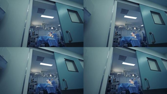 走廊的手术室。医生在现代手术室进行手术。从门口看。医疗保健概念。