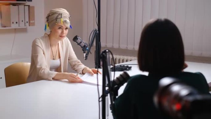 现代女性在播客工作室采访一位无法识别的女性客人