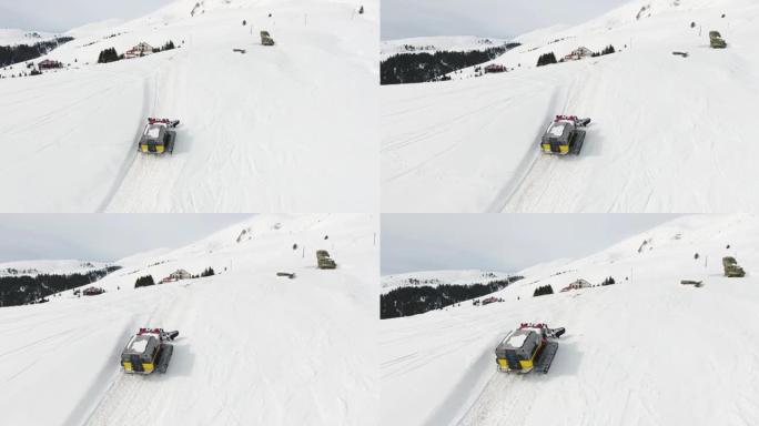 一群滑雪者和滑雪者的雪猫ratrack的空中无人机视图，在未触及的新鲜山雪上进行极端的自由骑行 (自