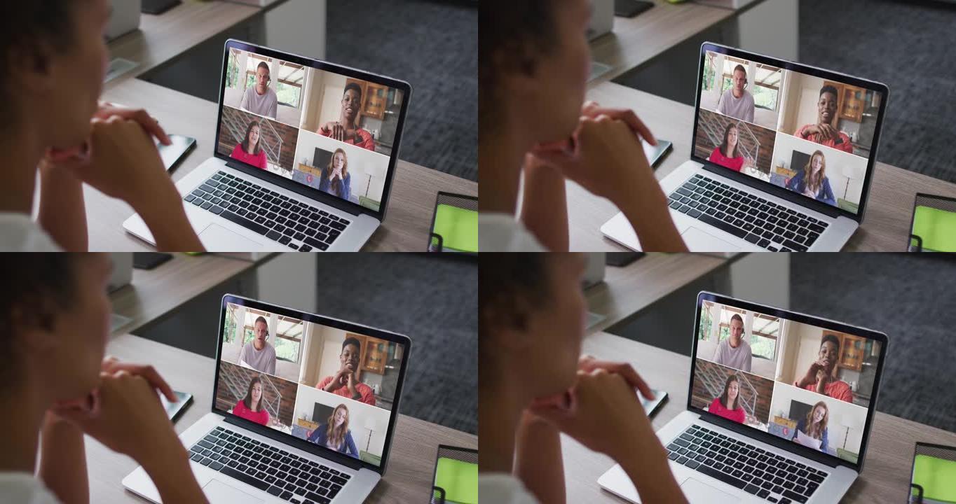 非裔美国妇女在办公室与同事在笔记本电脑上进行视频会议