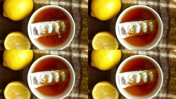 药丸掉进一杯柠檬茶中，特写。秋寒，病