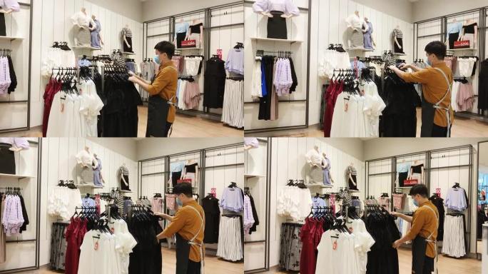 亚洲华人女性精品店服装店老板工作整理服装