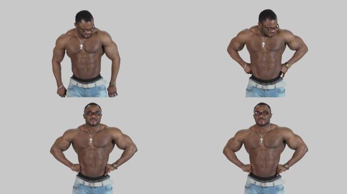 皮肤黝黑的肌肉发达的运动员肖像。非裔美国运动员不穿衬衫在演播室摆姿势。健康的生活方式。