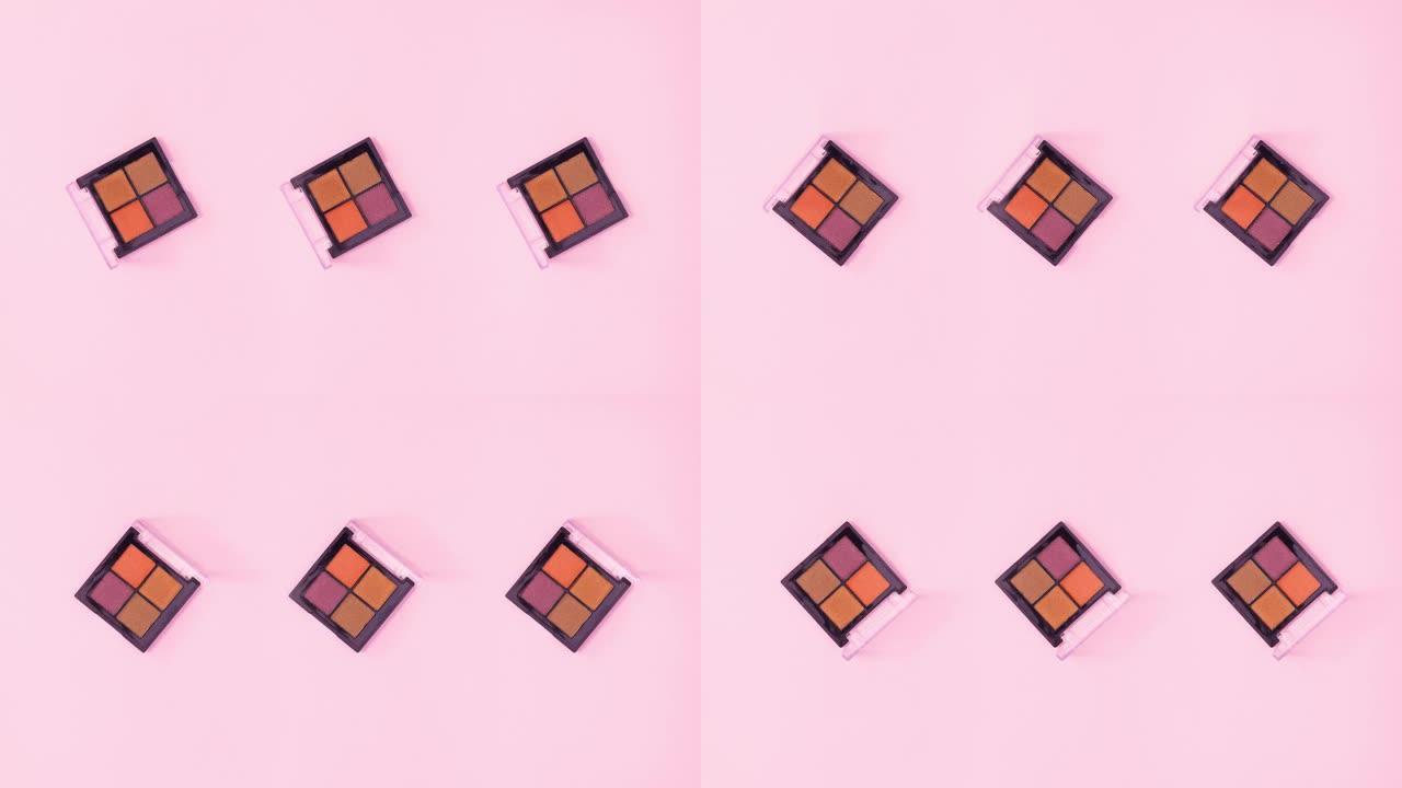 三个眼影调色板，四种颜色在明亮的粉红色主题上旋转。停止运动
