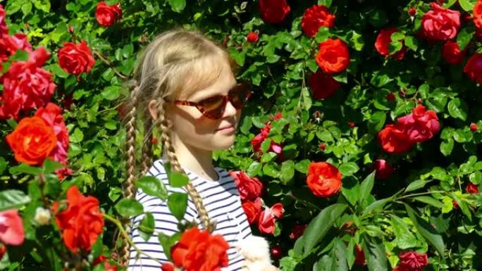 戴着太阳镜扎着辫子的女孩在玫瑰园摆姿势