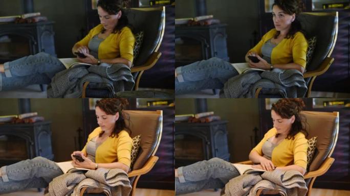 女人在家看书时使用应用程序开灯