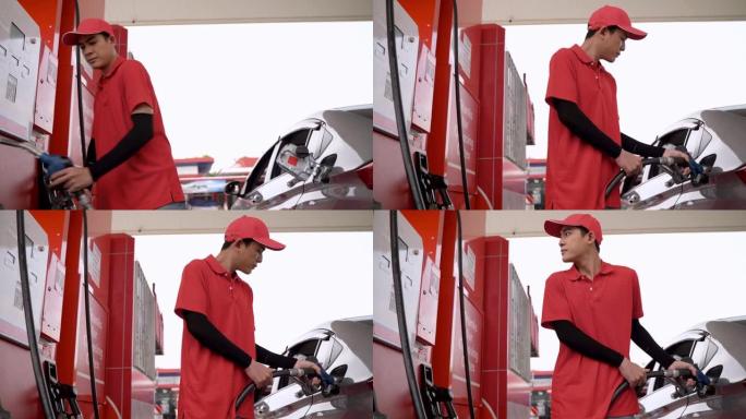 工人手持汽油在气泵处泵送燃油。男子在加油站给汽车加油。在加油站给汽车加油。将燃油泵入油箱。