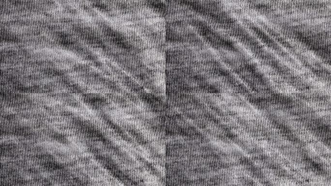 黑白粗麻布纹理背景微距拍摄。详细的灰色织物布背景，带平移运动。