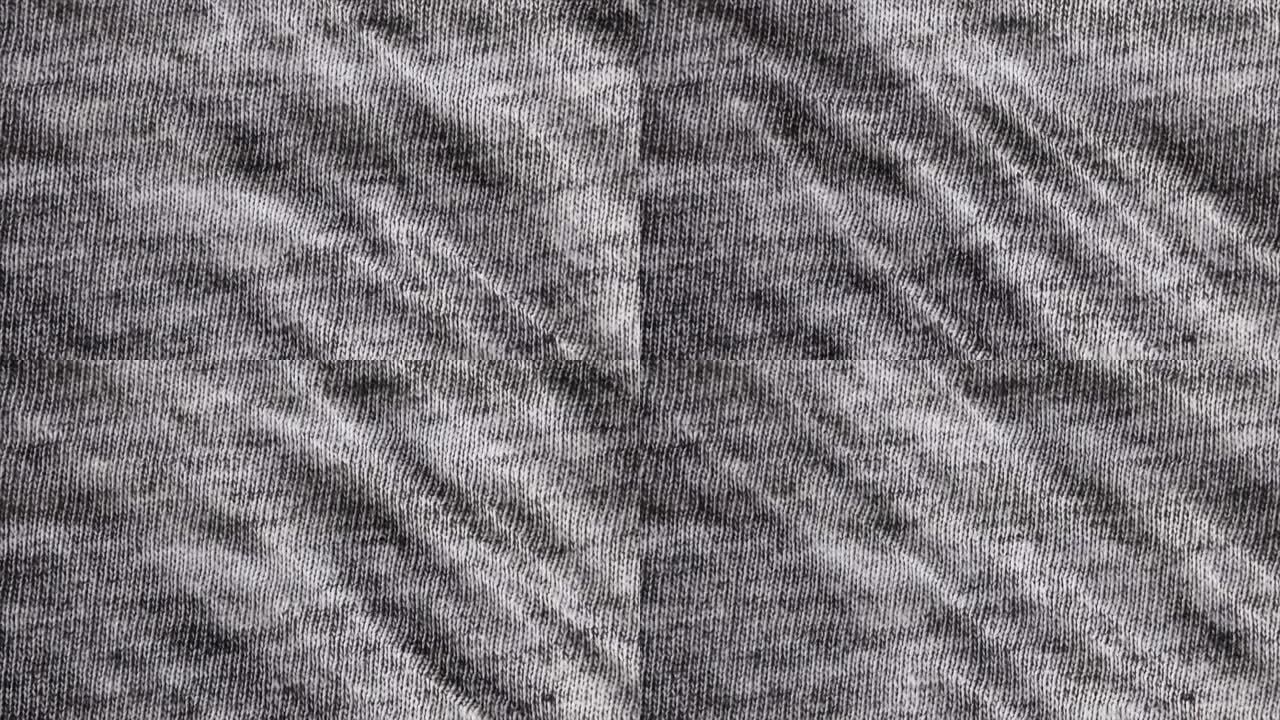 黑白粗麻布纹理背景微距拍摄。详细的灰色织物布背景，带平移运动。