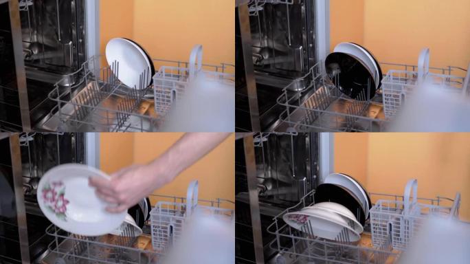 人类将未洗过的脏盘子放在洗碗机的架子上。4K