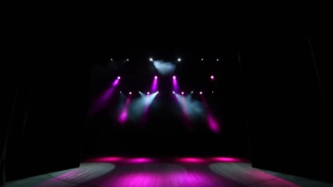 舞台灯光在讲台上闪烁。有粉红色聚光灯的剧院的舞台。