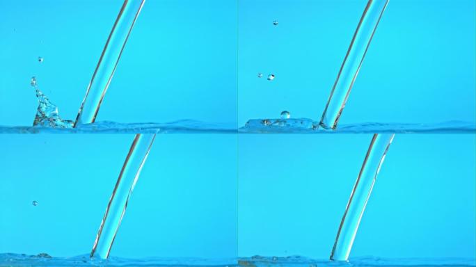超级慢动作喷射的水在蓝色背景下倾泻。以1000 fps的高速相机拍摄。