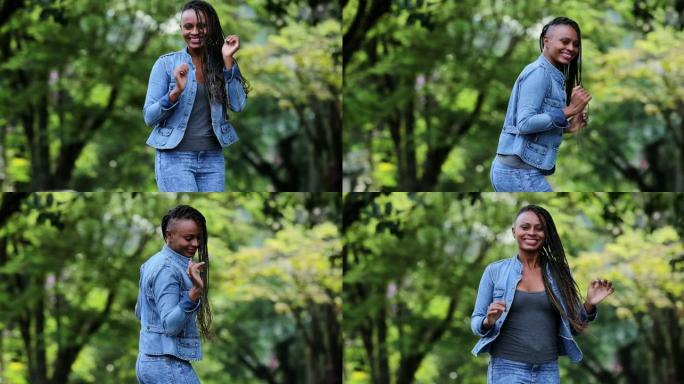 一个快乐的非洲女人在外面欢呼雀跃。庆祝成功的人跳舞