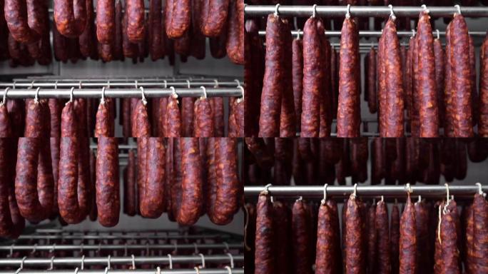 典型的西班牙干香肠、香肠的特写视图，挂在肉类加工厂储藏室的架子上。高质量全高清镜头