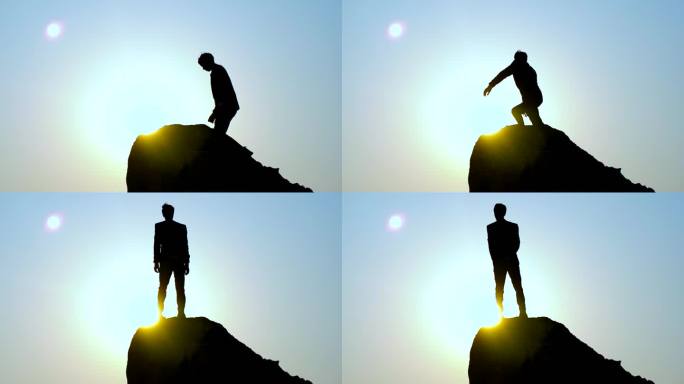 男人逆光爬山登山成功站在山顶眺望远剪影